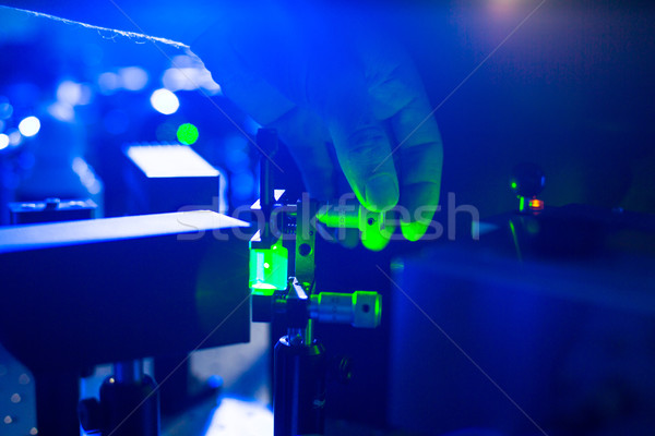 Quantum optics - hand of a researcher adjusting a laser beam Stock photo © lightpoet