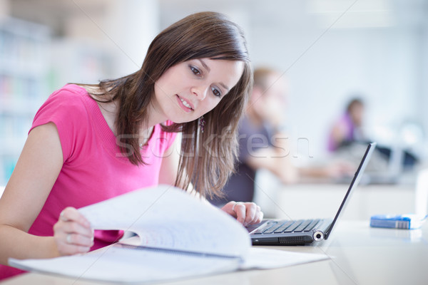 female student with laptop and books working in a high school library Stock photo © lightpoet