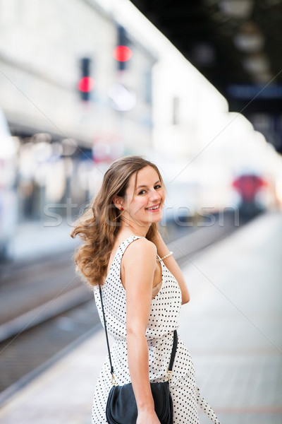 Stock photo: Pretty young woman at a train station