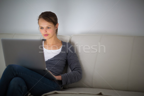 Pretty, young woman using her laptop computer at home Stock photo © lightpoet