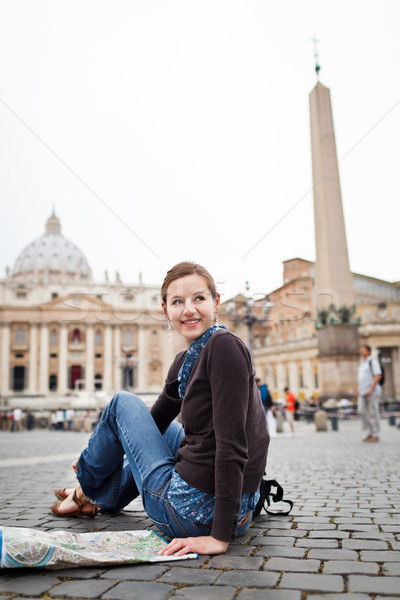 Pretty young female tourist studying a map at St. Peter's square Stock photo © lightpoet