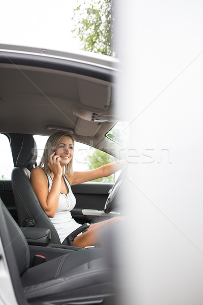 Pretty, young woman in her modern car in a parking lot Stock photo © lightpoet