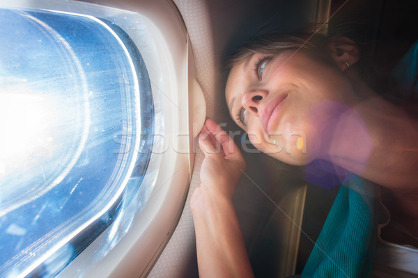 Happy, female airplane passanger Stock photo © lightpoet