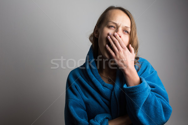 Stock photo: Sleepy young woman with wide open mouth yawning