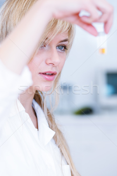 Stock photo: female researcher/chemistry student carrying out experiments in a lab