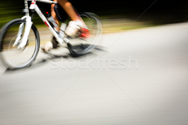 Cyclist on a road bike going fast (motion blur technique is used Stock photo © lightpoet