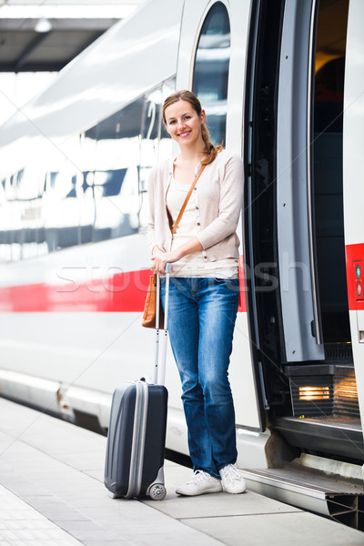 Stock photo: Pretty young woman boarding a train (color toned image)