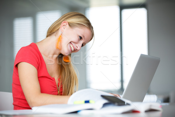 In the library - female student with books, papers and laptop Stock photo © lightpoet