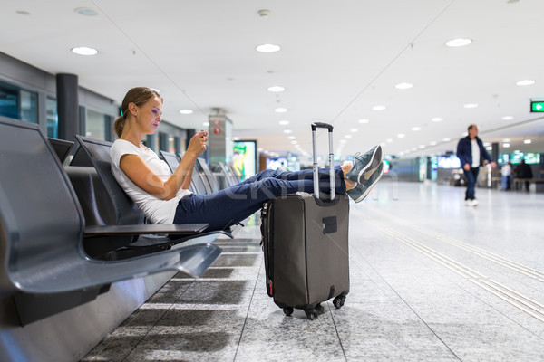 Young female passenger at the airport, using her tablet computer Stock photo © lightpoet