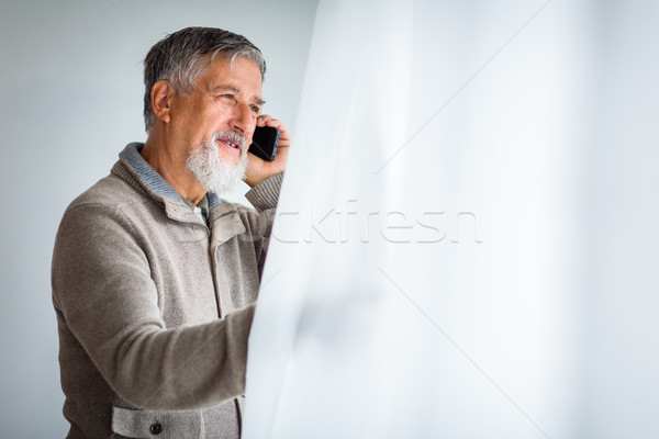 Handsome senior man calling on his cell phone  Stock photo © lightpoet