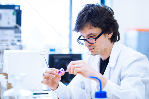 Young male researcher carrying out scientific research in a lab  Stock photo © lightpoet