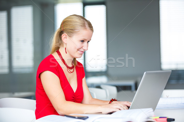 In the library - female student with books, papers and laptop Stock photo © lightpoet