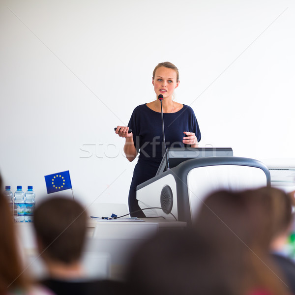 Stock photo: Pretty, young business woman giving a presentation