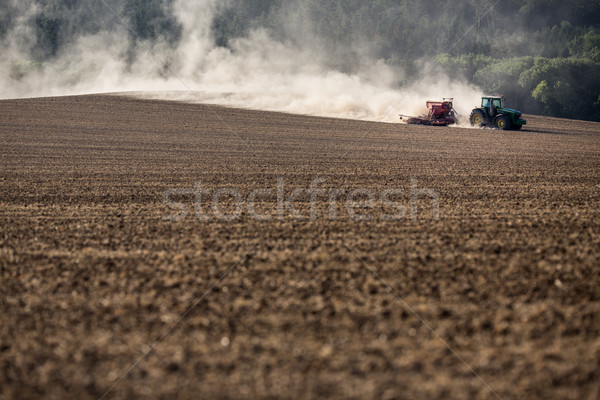 Tractor plowing a dry farm field Stock photo © lightpoet