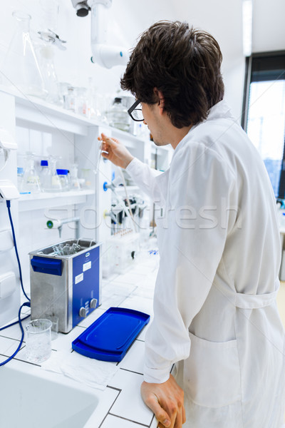 Young male researcher carrying out scientific research in a lab  Stock photo © lightpoet