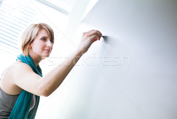 pretty young college student writing on the chalkboard Stock photo © lightpoet