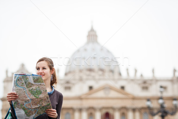Pretty young female tourist studying a map at St. Peter's square Stock photo © lightpoet