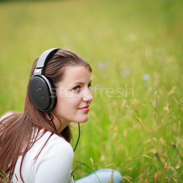 portrait of a pretty young woman listening to music Stock photo © lightpoet