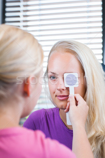 Young female patient having her eyes examined by an eye doctor Stock photo © lightpoet