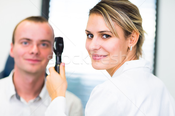 Optometry concept - handsome young man having her eyes examined  Stock photo © lightpoet