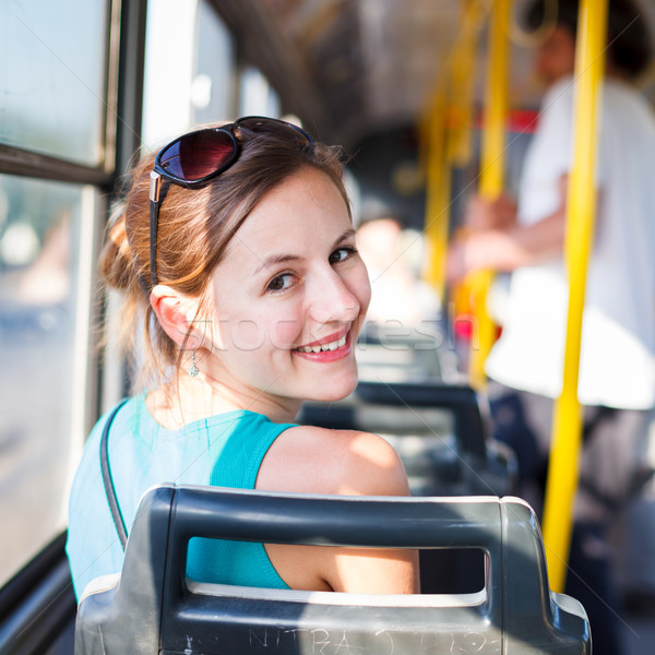 Pretty, young woman on a streetcar/tramway, during her commute t Stock photo © lightpoet