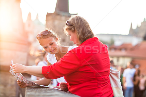 Mother and daughter traveling - two tourists studying a map Stock photo © lightpoet