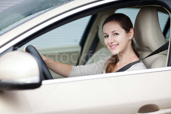 Pretty young woman driving her new car  Stock photo © lightpoet