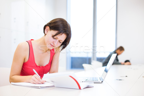 Pretty, young college student studying in the library Stock photo © lightpoet