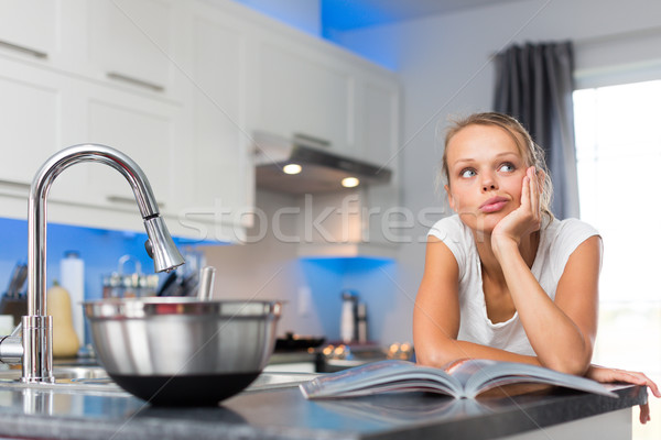Pretty, young woman in her modern, clean and bright kitchen Stock photo © lightpoet
