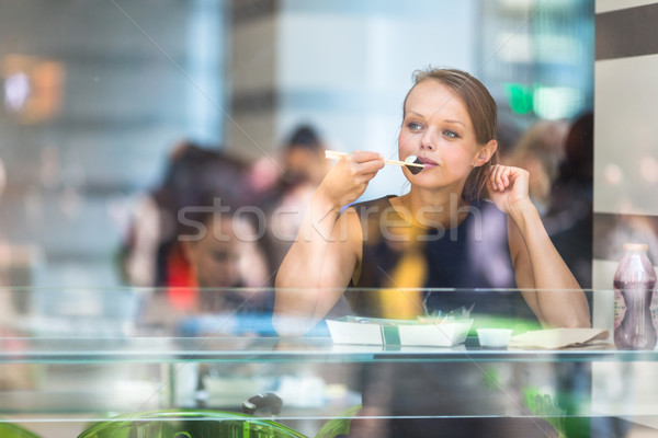 Pretty, young woman eating sushi in a restaurant Stock photo © lightpoet