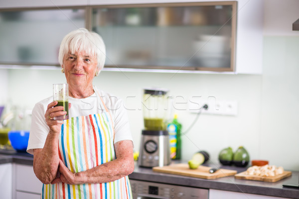 Senior woman cooking in the kitchen - eating and cooking healthy Stock photo © lightpoet