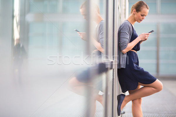 Portrait of a sleek young woman calling on a smartphone Stock photo © lightpoet