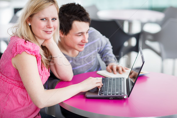 Two college students having fun studying together, using a lapto Stock photo © lightpoet