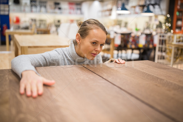 Pretty, young woman choosing the right furniture  Stock photo © lightpoet