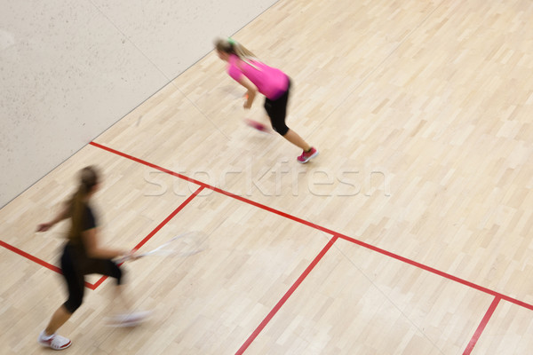 Two female squash players in fast action on a squash court Stock photo © lightpoet