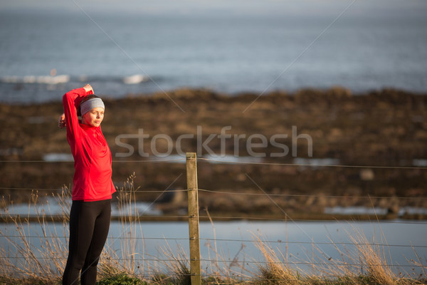 Young woman on her evening jog along the seacoast Stock photo © lightpoet
