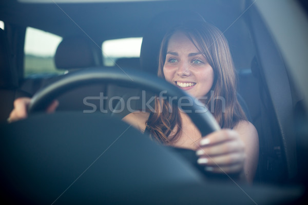 Cute teenager driving her brand new car Stock photo © lightpoet