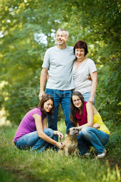 Family portrait - Family of four with a cute dog outdoors Stock photo © lightpoet