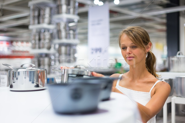 Pretty, young woman choosing a the right pot Stock photo © lightpoet