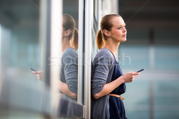 Portrait of a sleek young woman calling on a smartphone  Stock photo © lightpoet