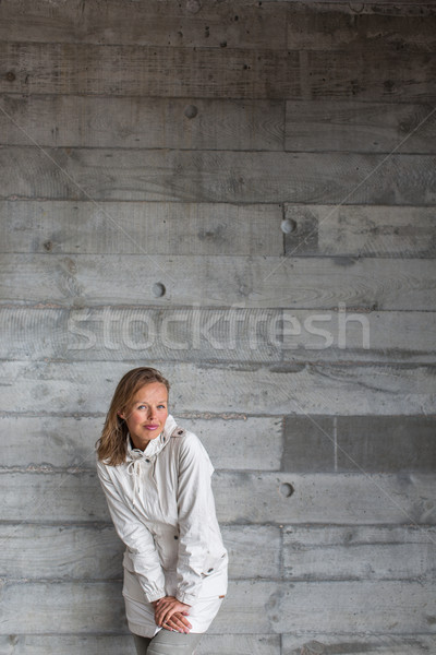 Pretty, young woman in front of a concrete wall  Stock photo © lightpoet