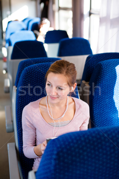 Young woman using her tablet computer while traveling by train Stock photo © lightpoet