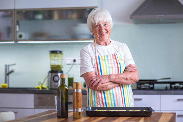 Senior woman/grandmother cooking in a modern kitchen  Stock photo © lightpoet