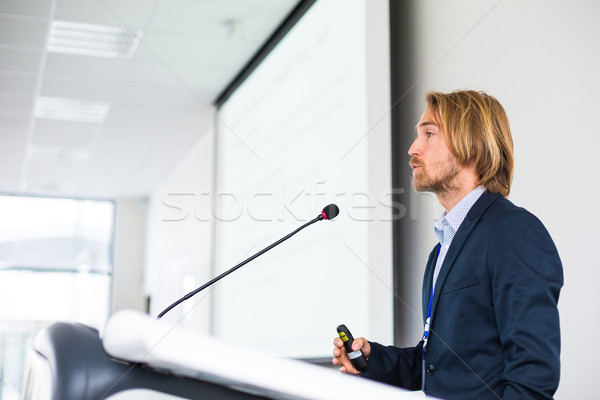 Handsome young man giving a speech at a conference Stock photo © lightpoet