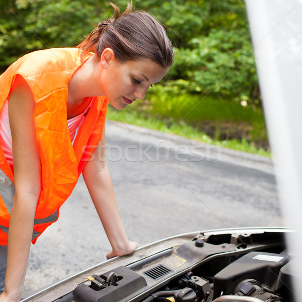 Young female driver bending over  the engine of her broken down car Stock photo © lightpoet