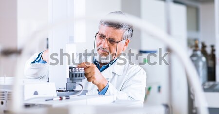 Stock photo: Senior male researcher carrying out scientific research in a lab