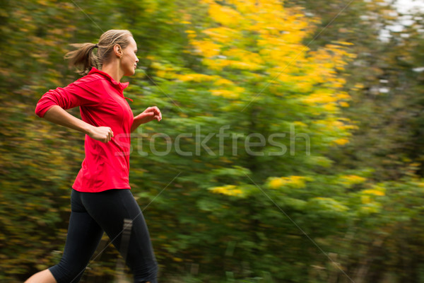 Young woman running outdoors in a city park on a cold fall/winte Stock photo © lightpoet