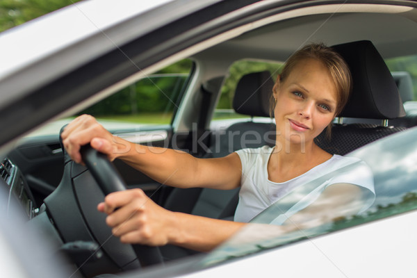 Young woman driving her car, on her way home from work Stock photo © lightpoet