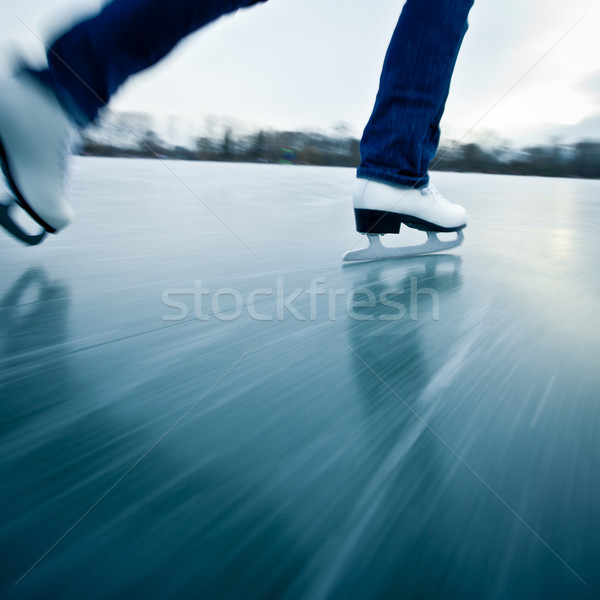 Young woman ice skating outdoors on a pond Stock photo © lightpoet