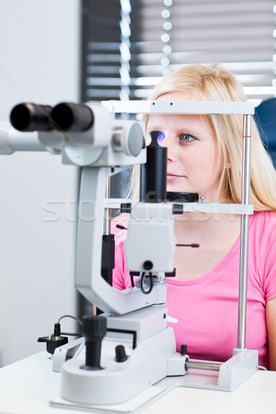 young female patient having her eyes examined by an eye doctor Stock photo © lightpoet